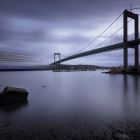 Light trails from a passenger cruise under Suspension bridge at Gothenburg Connecting main land to Industrial area of Hisingen in west coast of Sweden.